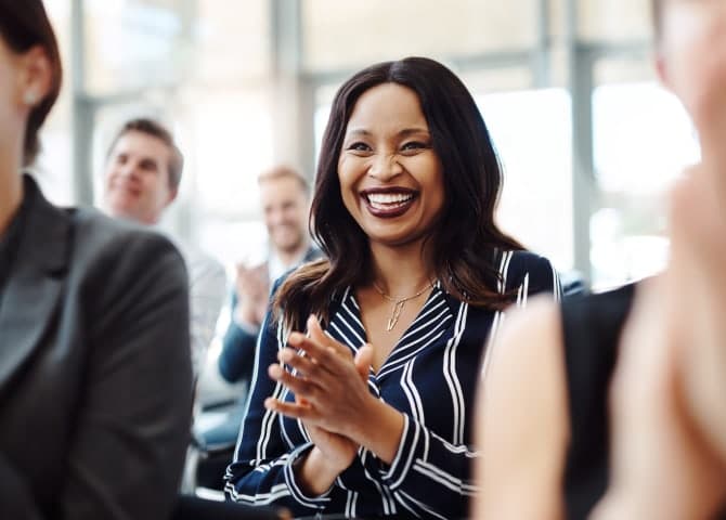 a woman happy and clapping her hands