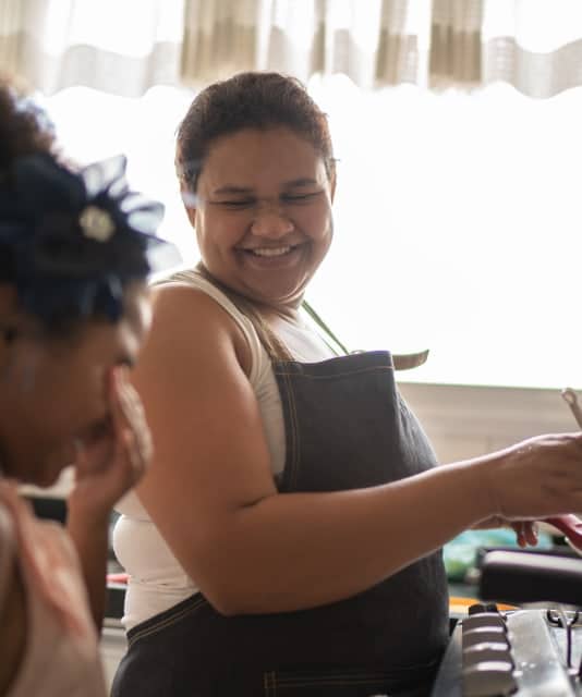 Two women smiling in a kitchen