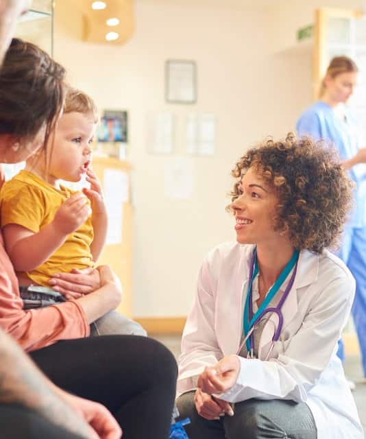 a woman doctor looking at a baby